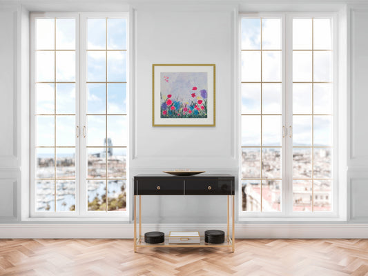 Modern interior with a console table, framed artwork, and large windows with a cityscape view.