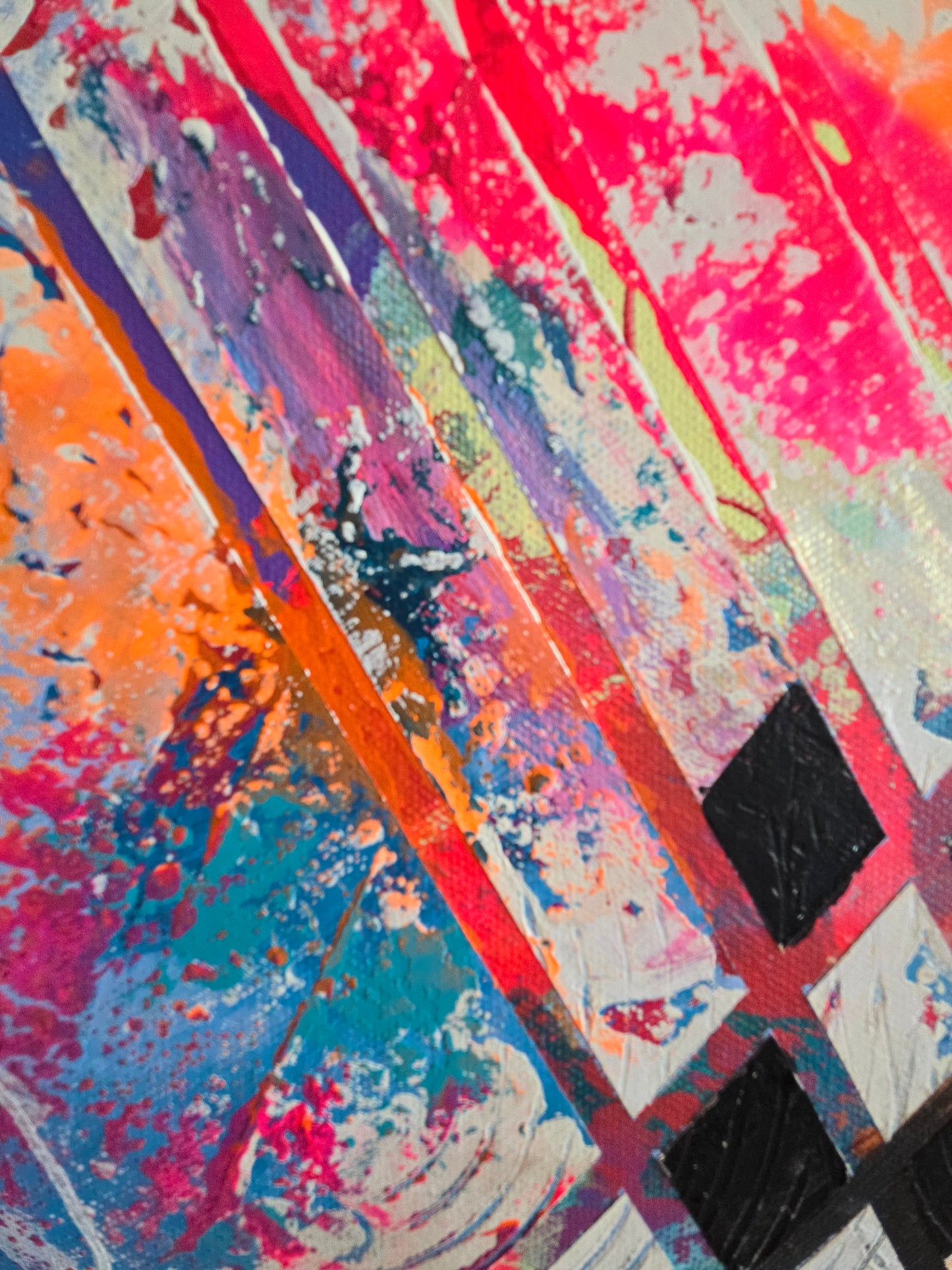 Detail image featuring splashes of pink, blue, orange, and black.