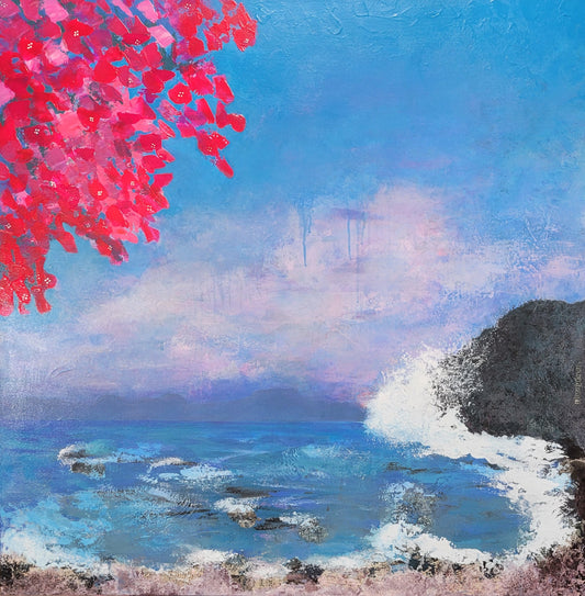 Breaking waves on a rock with a colorful sky and bougainvillea flowers.